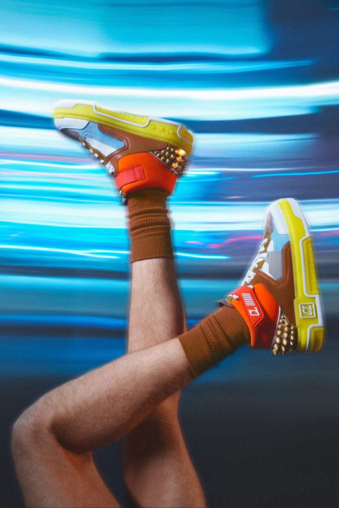 After making its debut in the Paris Fashion Week, this spunky collection has finally arrived in India. Christian Louboutin's latest creation, The ASTROLOUBI, draws inspiration from the bold trends of the 90s. Reminiscent of iconic basketball and skate sneakers from that era, these shoes pay homage to a time when fashion was fearless. The ASTROLOUBI is not just a tribute; it's a modern reinvention. Christian Louboutin Astroloubi sneakers Available in five captivating colorways, the collection ranges from vibrant 90s hues to soothing pastels and a sleek minimalist version, each iteration is a testament to the fusion of materials and textures. While giving off a cool streetwear vibe, the sneakers flaunt luxurious calfskin leather, supple suede, sleek satin, and laminated nappa blend. The collection features bold graphic lines, distinctive spikes embellishing the back counter, a vibrant outsole adorned with the 'CL' varsity logo, and, naturally, the iconic red sole, a representation of Maison's unique style. Christian Louboutin Astroloubi sneakers The sneaker is 20% lighter than its all-leather counterparts. The design prioritizes weightlessness with a lycra-covered open foam Loubi red footbed, promoting breathability and relaxation. The shoe also boasts a fast-drying red lining, ideal for those seeking durability on the court. 